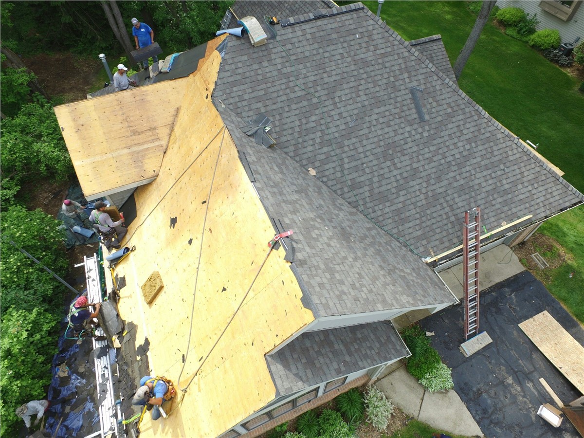 A residential roof with newly installed shingles and visible roofline details