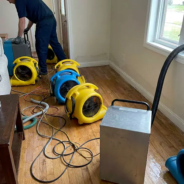Air-moving equipment positioned to dry a residential room after an indoor water release